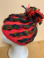 Hand-knit hat, pink with dark knit stripes, and Pom Pom on top