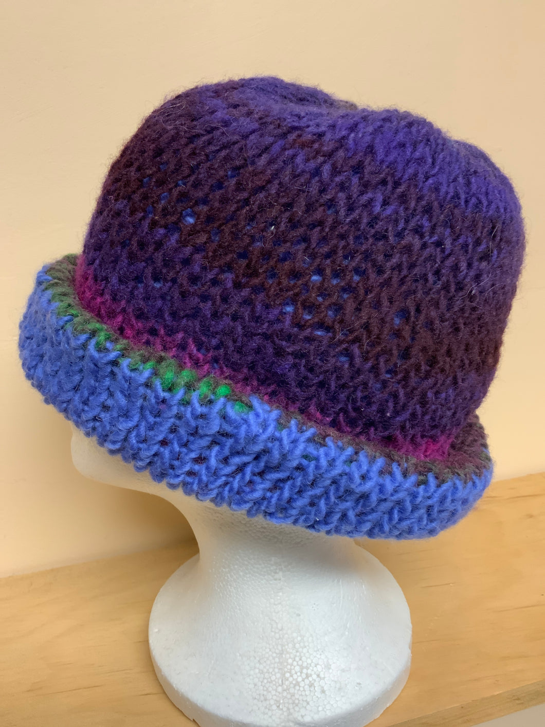 Hand-knit reversible hat, blue on one side, purple shades on the other