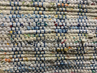 24” x 39” a white rug with specks of color, blue and white warp