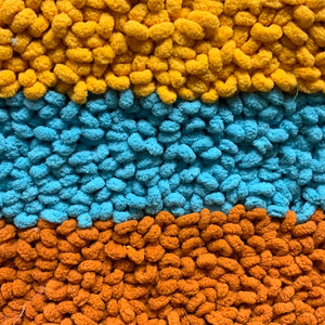 Yellow, turquoise and rust soft poly pile 24” x 35”