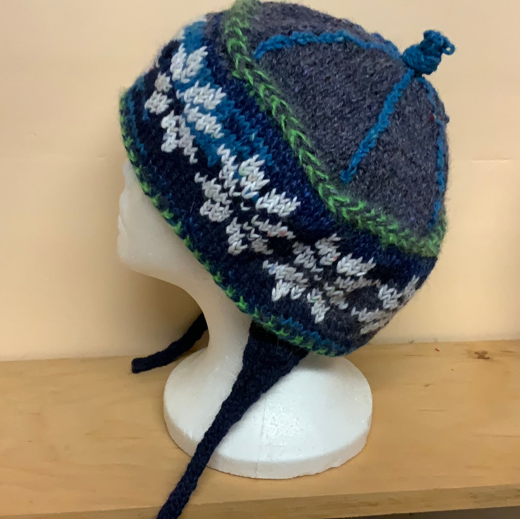 Snowflakes circle a band of navy and gray on this hat with ear warmers to tie under your chin