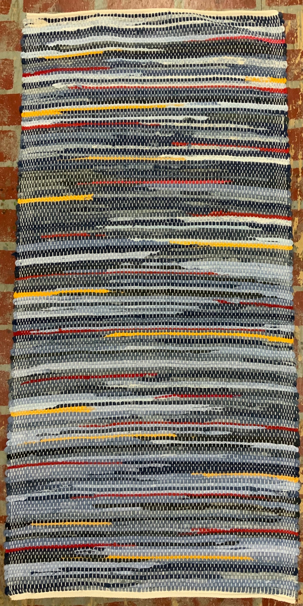 Denim with red and yellow stripes rag rug 30” x 64”