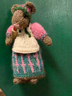 Mouse with green and pink dress, holding rolling pin