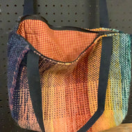 Hand-woven wool bag of many colors, roomy and lined, closes with a zipper