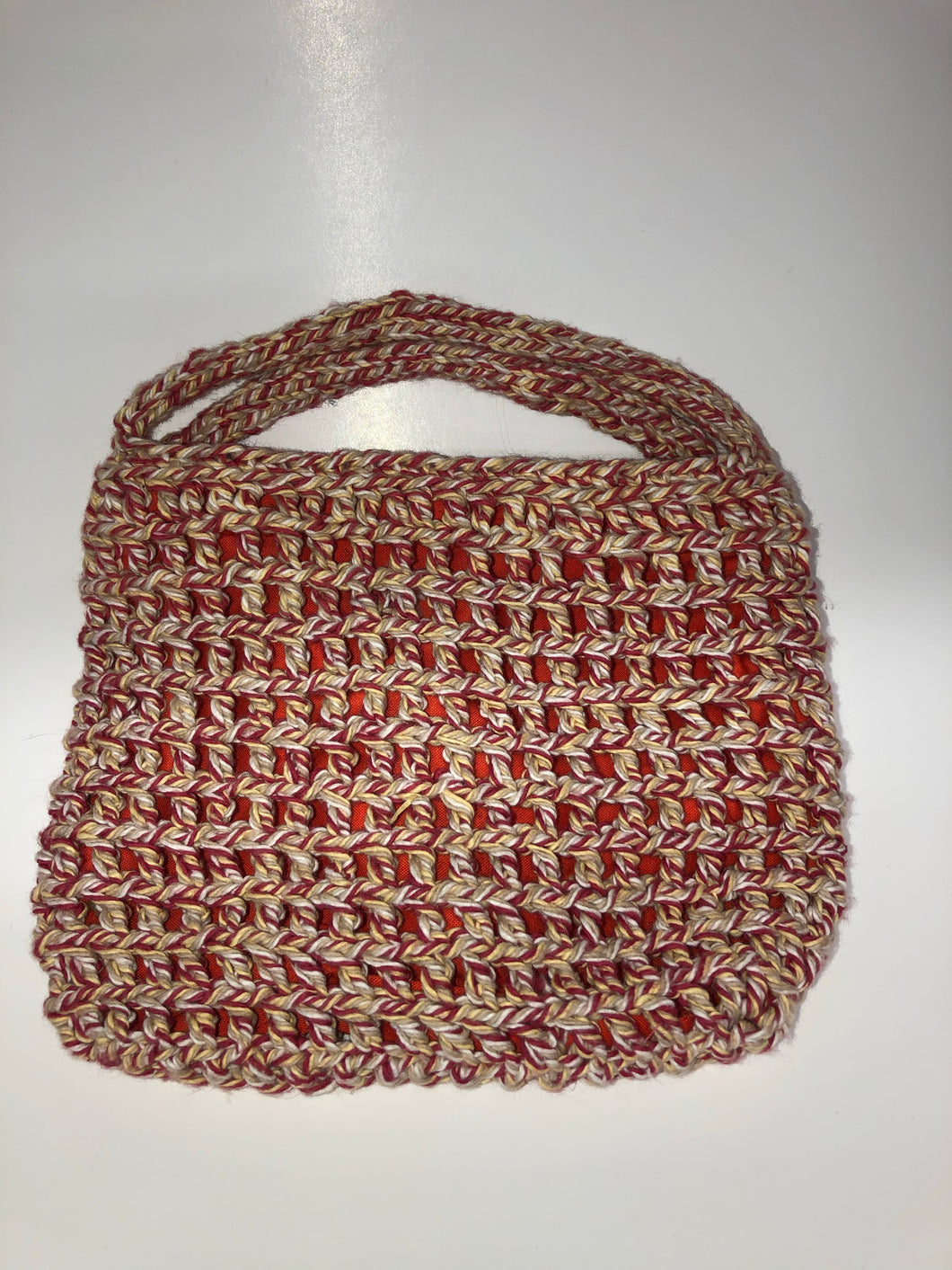 Red and white knit bag with orange lining