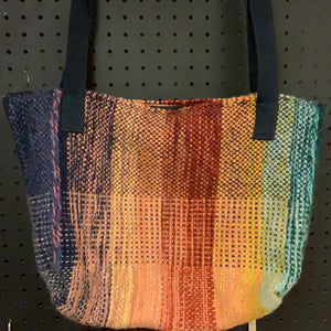 Hand-woven wool bag of many colors, roomy and lined, closes with a zipper