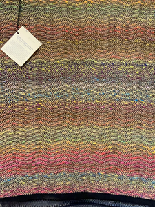 Brown and multicolored wool yarn woven in a wave pattern.  Rug is 28” x 43”