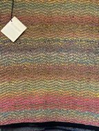 Brown and multicolored wool yarn woven in a wave pattern.  Rug is 28” x 43”