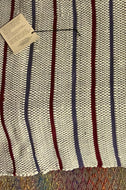 Oyster white with burgundy & purple stripes.  24” x 40”